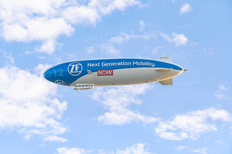Zeppelin advertising new mobility in a blue sky with clouds, Überlingen, Lake Constance, Germany