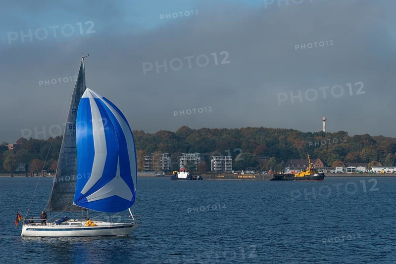 Kiel Fjord, Holtenau district, sailing yacht with spinnaker, tugboat, modern buildings, Kiel, slope, forest, Baltic Sea, Schleswig-Holstein, Germany