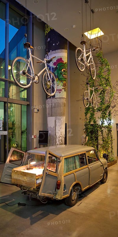 Entrance area to Monkey Bar with old Trabi in the evening, Charlottenburg, Berlin, Germany