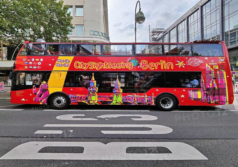 Double-decker bus for the city tour on Tauentzienstraße with Kaiser Wilhelm Memorial Church, Charlottenburg, Berlin, Germany