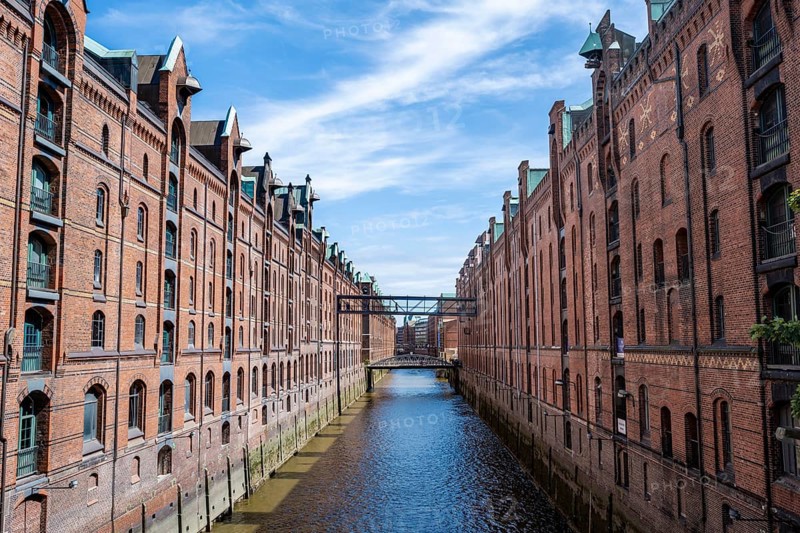 Canal between red brick buildings, warehouses in Hamburg's Speicherstadt, Hamburg, Germany