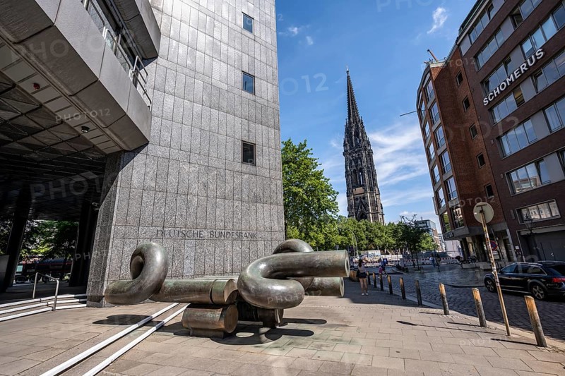 Deutsche Federal Bank building with modern sculpture, tower of the destroyed St. Nikolai church in the back, Hamburg, Germany