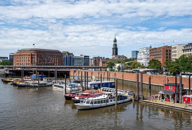 Boats in the inland port at the mouth of the Alster, St. Michaelis church in the back, Hamburg, Germany