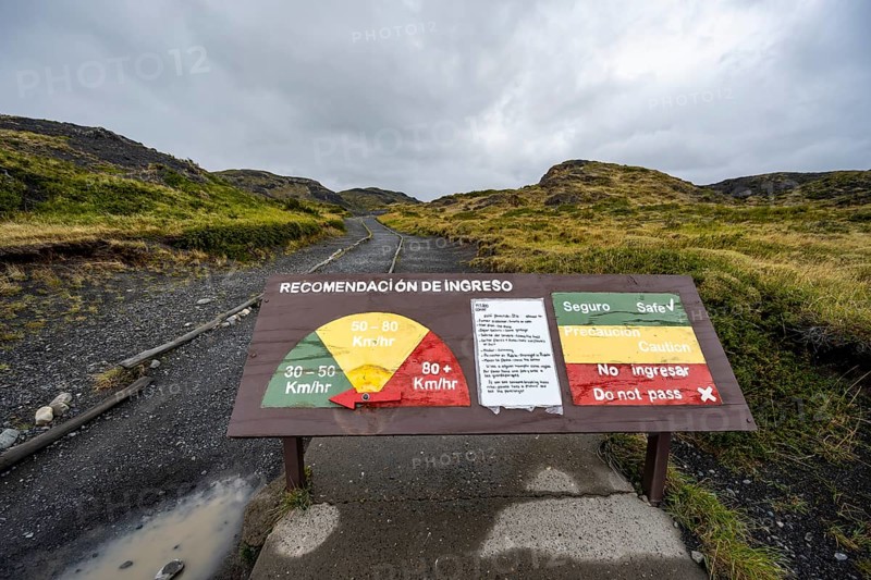 Warning sign for strong winds, gusts of wind on a hiking trail, Torres del Paine, Chile