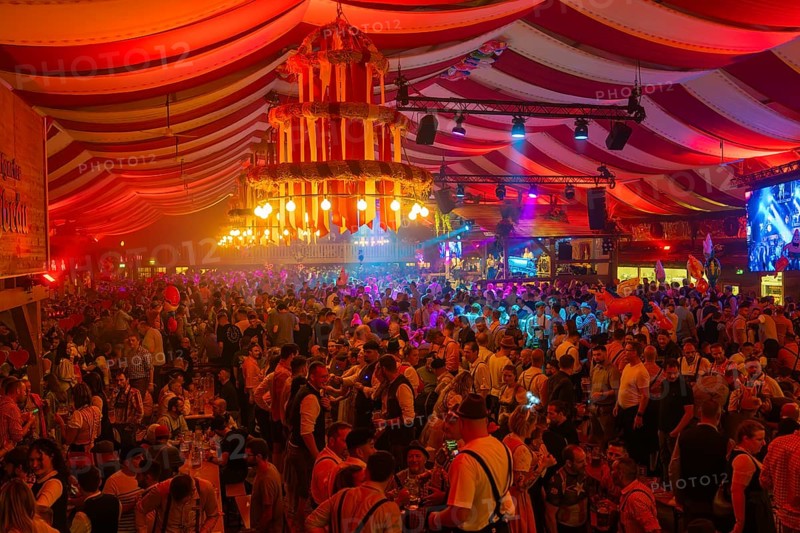 Lively and colourful celebration in a large beer tent full of people and bright decorations, Volksfest Cannstatter Wasen, Sonja Merz Festzelt, Stuttgart, Germany
