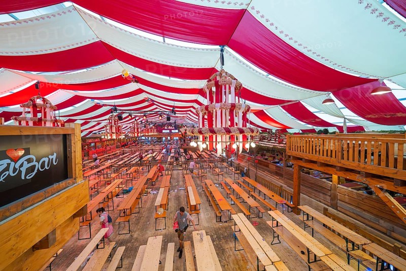 Marquee with red ceilings and wooden benches, bar in the foreground, inviting atmosphere, Cannstatter Wasen folk festival, Sonja Merz marquee, Stuttgart, Germany
