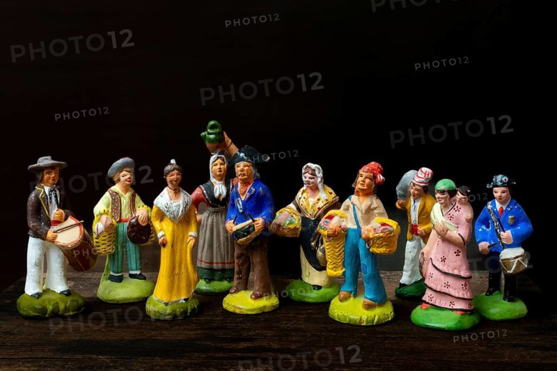Colorful Provençal terracotta figurines represent traditional characters from rural life. Each figure is uniquely crafted, depicting musicians, farmers, and market sellers in detailed attire