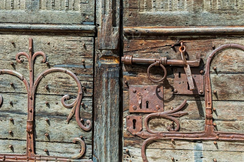 Ancient lock and mechanism of the Romanesque church of Mailhat in Puy de Dome, Auvergne Rhone Alpes, France