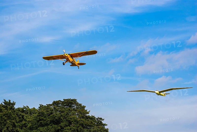 A Piper PA-18 Super Cub tows a glider during an air show at the Rossfeld in Metzingen-Glems, Baden-Württemberg, Germany, for editorial use only