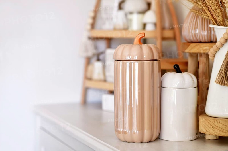Boho autumn home decor with ceramic pumpkin jars with copy space