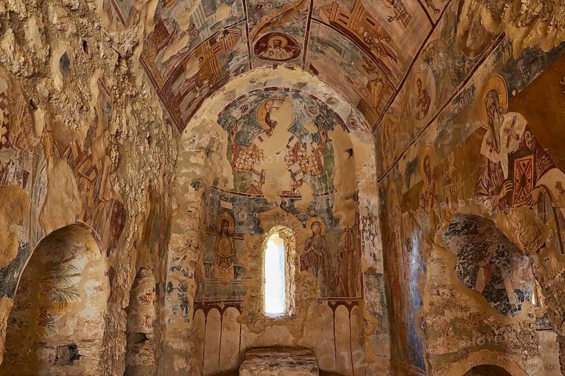 Post-Byzantine church of Agios Nikolaos from the 17th century AD, Painted frescoes in an ancient stone chapel show sacred motifs, illuminated through a window, Mystras, Mistra, UNESCO World Heritage Site, Medieval Byzantine ruined city, northwest of Sparta, foothills of the Taygetos Mountains, Peloponnese, peninsula, Greece