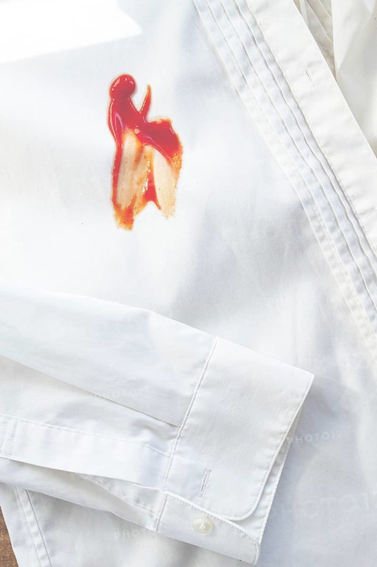 White shirt stained with ketchup, no people, close-up, selective focus