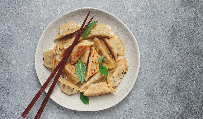 Japanese fried gyoza dumplings, with pork, sesame seeds, green onions