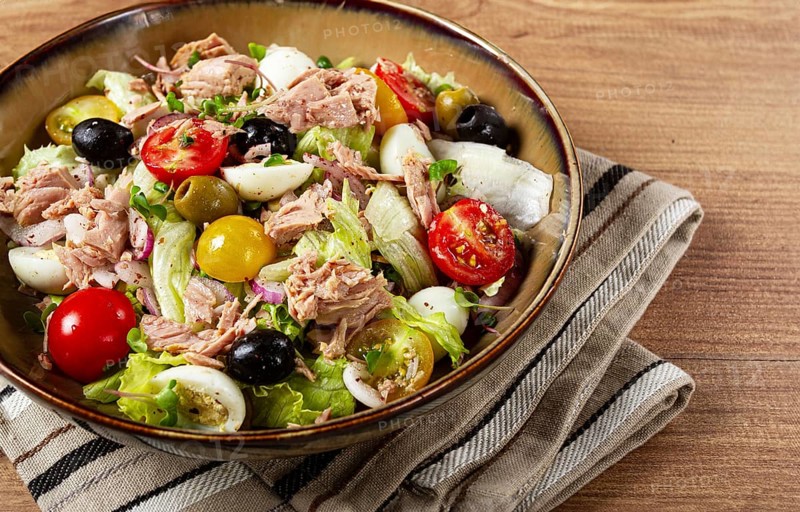 Salad with canned tuna, vegetable salad with quail eggs, lettuce, red onion, cherry tomatoes, olives, keto food, healthy food, homemade, no people