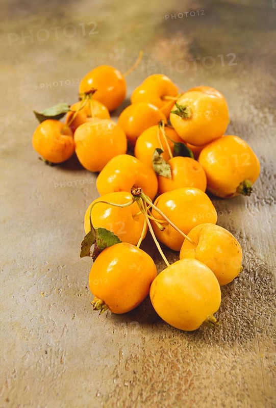 Yellow small apples, Chinese variety, scattered on the table, top view, no people
