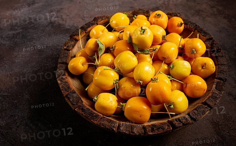 Yellow small apples, Chinese varieties, in a wooden bowl, top view, no people