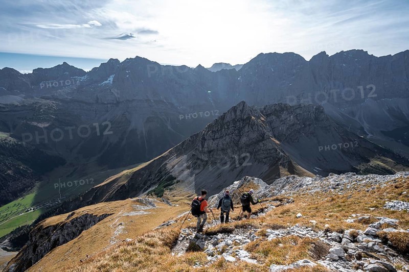 Group of mountaineers descending from the Gamsjoch, in autumn, mountain panorama with Spritzkarspitze and summit of the Hinterautal-Vomper chain, Rißtal in the Eng, Karwendel, Tyrol, Austria