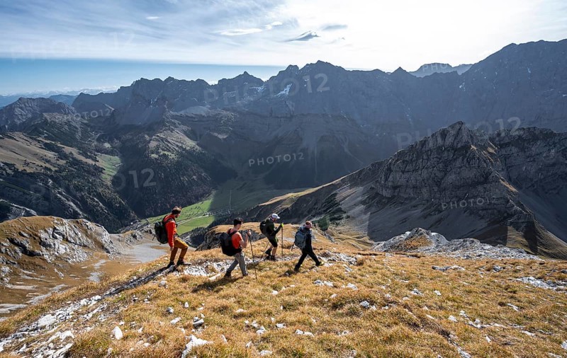 Group of mountaineers descending from the Gamsjoch, in autumn, mountain panorama with Spritzkarspitze and Lamsenspitze, Rißtal in the Eng, Karwendel, Tyrol, Austria