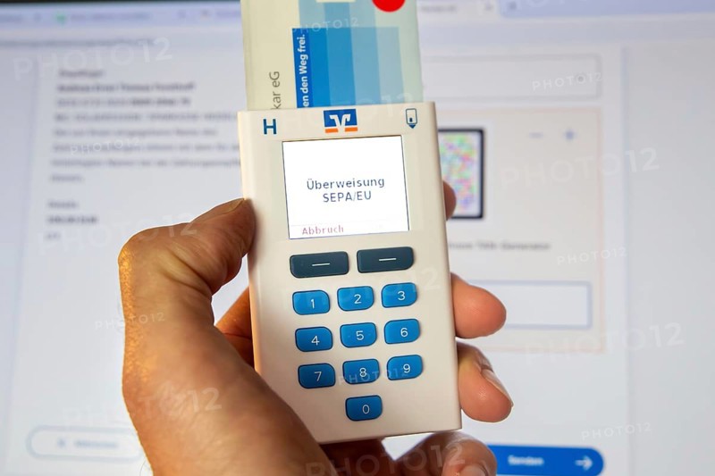 Online banking symbol image: Scanner for online banking in front of a bank website opened on a PC