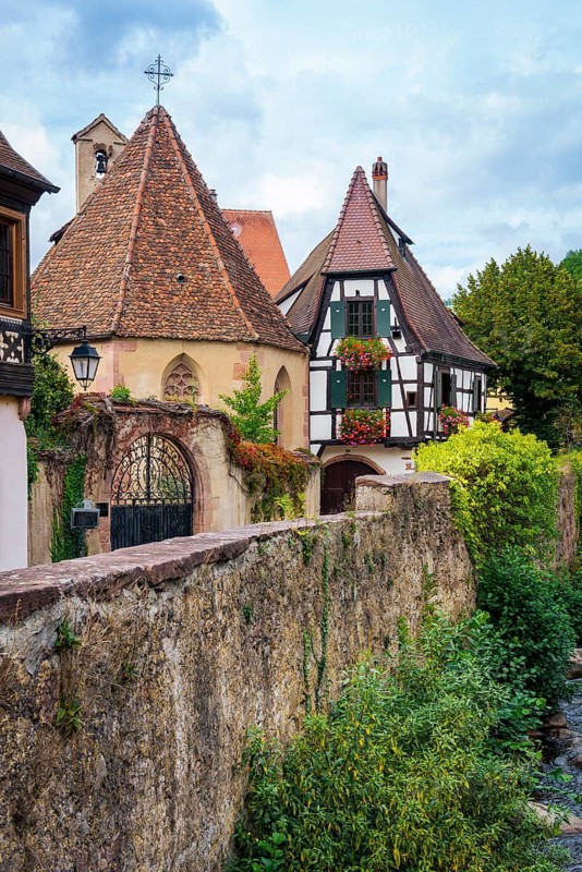 Picturesque Kaysersberg with half-timbered houses on the Weiss river in the old town centre