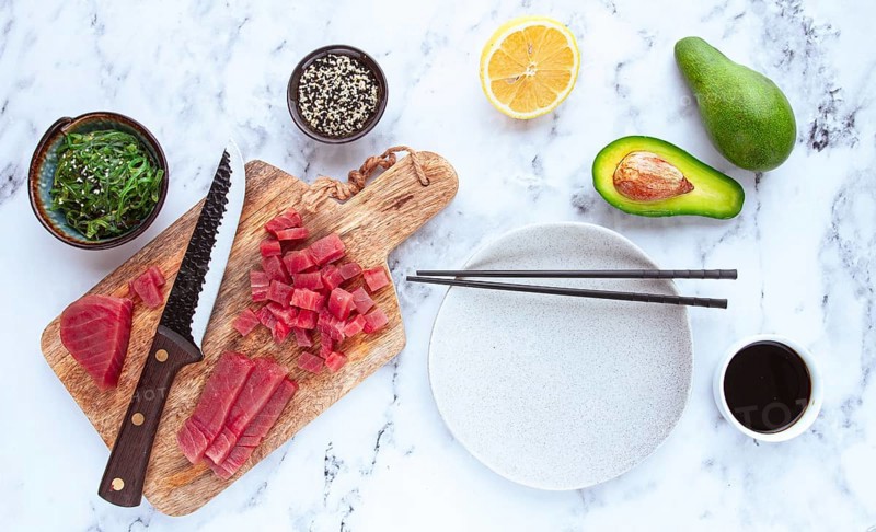Cooking fresh tuna with ingredients on a marble countertop, ingredients for making sushi and tuna tartare