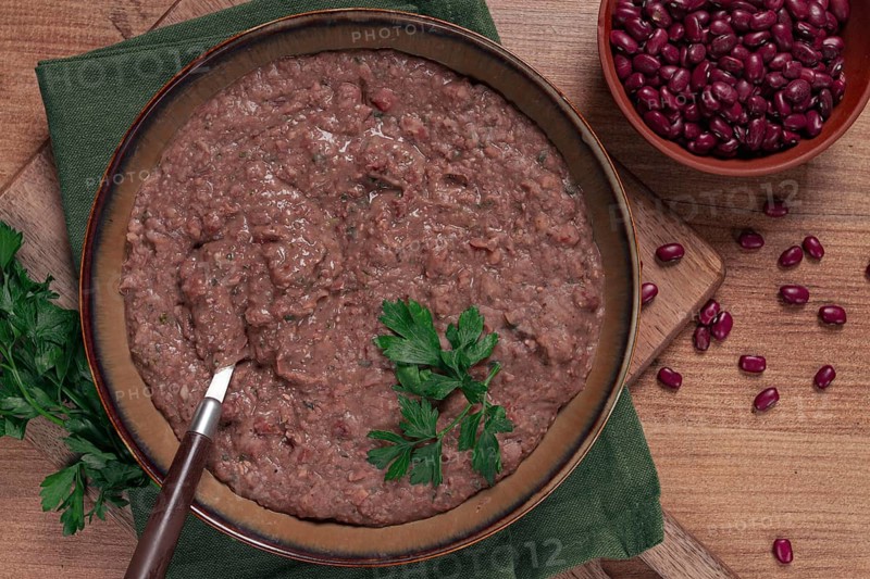 Red bean lobio, a traditional Georgian dish, on a wooden table, homemade