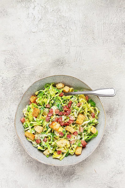 Brussels sprouts Caesar salad, with bacon and croutons, healthy food, homemade, no people