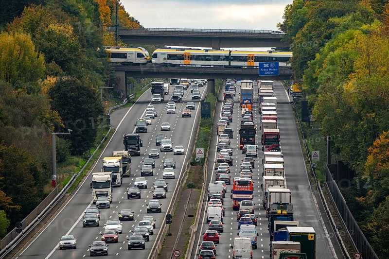 Local train crossing the A3 motorway between the Hilden junction and the Mettmann junction, view to the south, traffic jam due to construction work, North Rhine-Westphalia, Germany