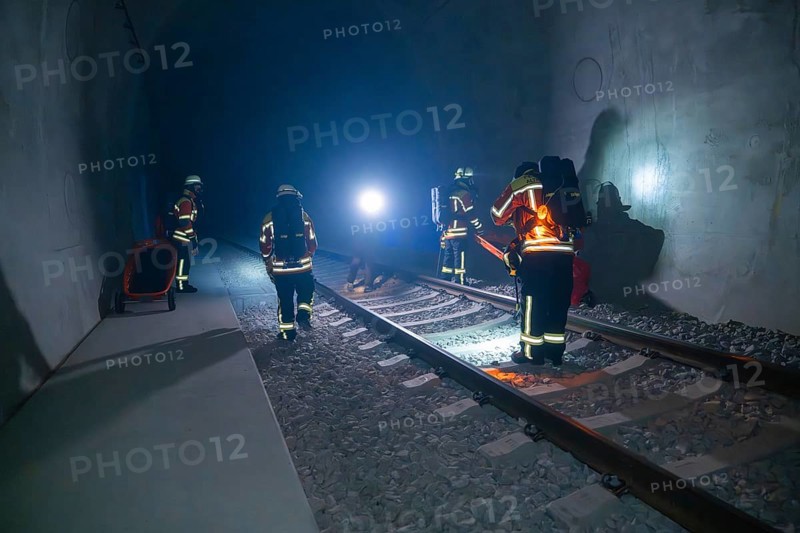 Firefighters working in the tunnel in the dark, accompanied by light sources, firefighting exercise in the new tunnel of the Hermann Hesse railway, Ostelsheim, district of Calw, Germany
