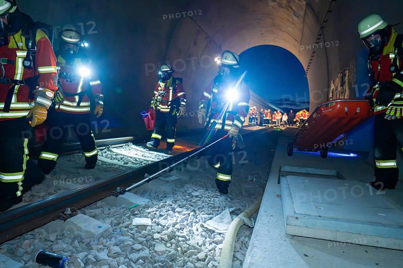 Firefighters in a tunnel at night, strong light illuminates the scene, firefighting exercise in the new tunnel of the Hermann Hesse railway, Ostelsheim, district of Calw, Germany
