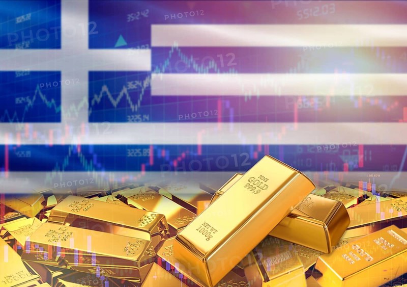 Gold bars on Greece flag in background. Gold bars stacked on Greek flag. Concept of Greece gold reserves