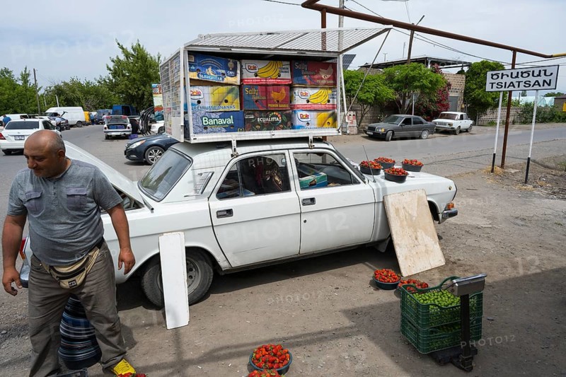 A car as an improvised roadside fruit market stall, selling fruit such as strawberries by the roadside, Tsiatsan, Armavir province, Armenia