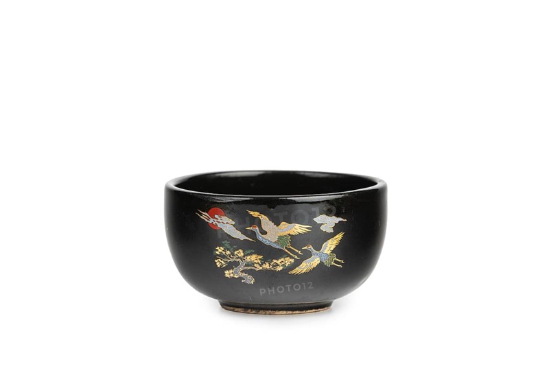 Black bowl with golden cranes, Asian decor, white background