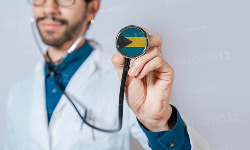 Doctor holding stethoscope with Bahamas flag. Bahamas health and care concept. Bahamas flag on stethoscope
