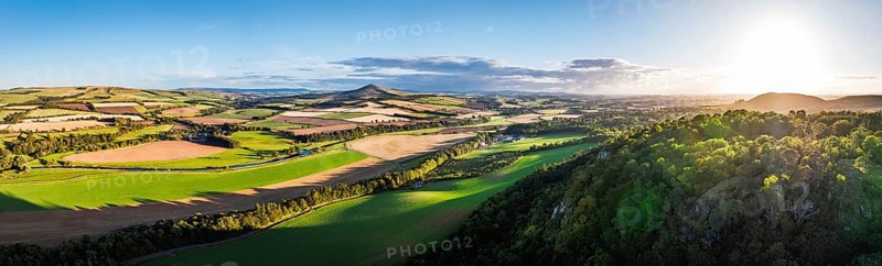 Panorama of evening Fields and Farms over River Teviot and Minto Crags from a drone, Roxburghshire, Scottish Borders, Scotland, UK