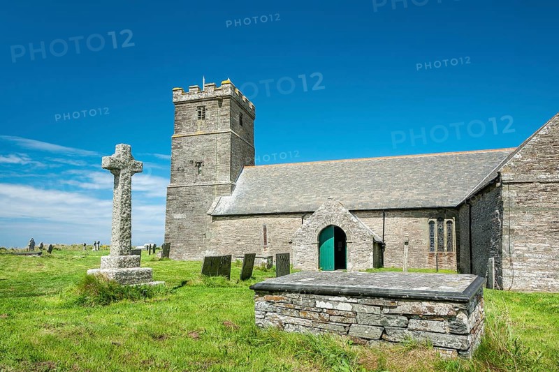 The Norman church of St Materiana with graveyard and stone cross, Tintagel, Cornwall, England, Great Britain