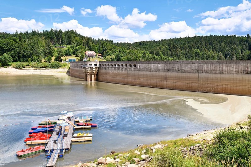 View on Schwarzenbach Dam (German: Schwarzenbachtalsperre) and reservoir in Forbach in the Northern Black Forest in Germany with boat dock and rental on a sunny summer day