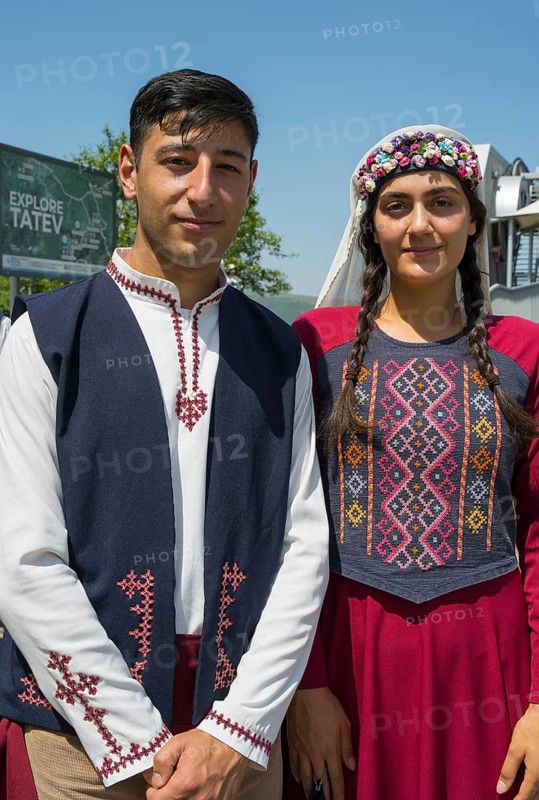 Close-up of a couple in traditional traditional costume in front of a sign, folklore, Tatev, Tatev, Syunik province, Syunik, Armenia