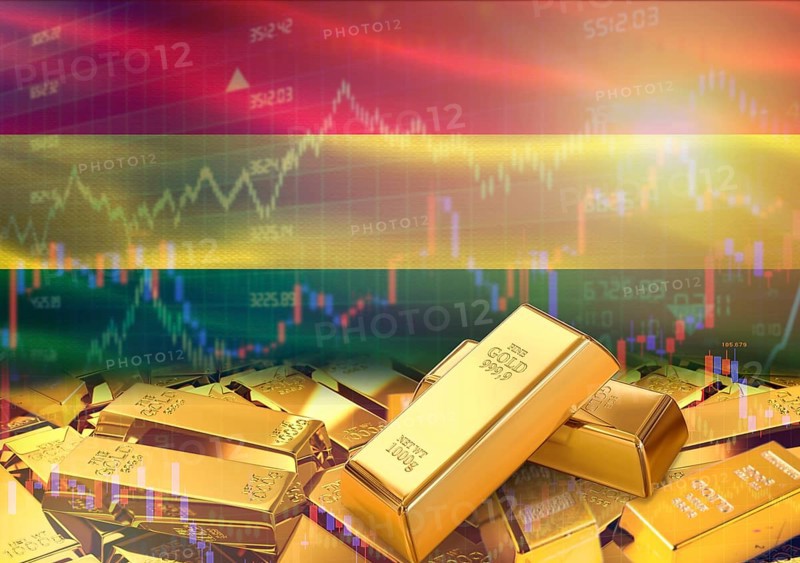 Gold bars on Bolivia flag in background. Gold bars stacked on Bolivian flag. Concept of Bolivia gold reserves