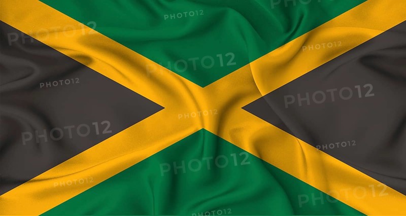 Realistic Jamaica flag waving. Close up of flag of Jamaica with cloth texture