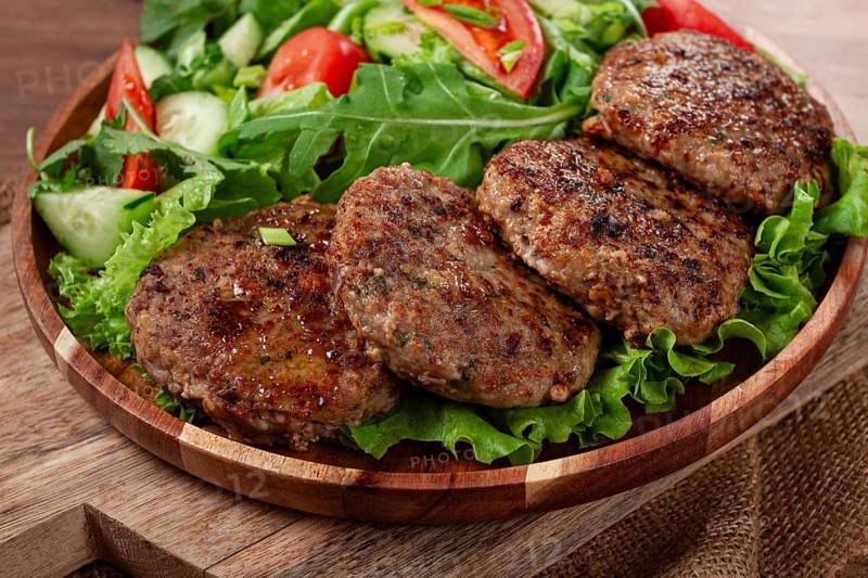 Fried cutlets, mixed minced meat, with vegetable salad, homemade, top view, no people