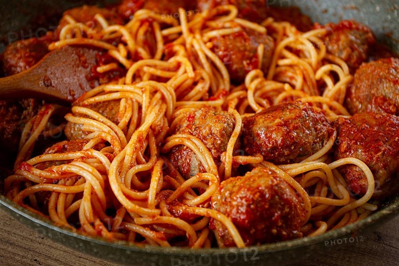 Spaghetti with meatballs, in tomato sauce, cooking in a frying pan, no people, homemade