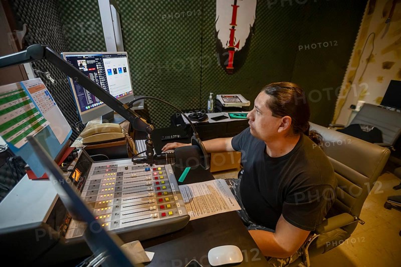 Porcupine, South Dakota - Lucian Little White Man broadcasts on KILI Radio, the voice of the Lakota Nation. The station broadcasts in Lakota and English to the Pine Ridge, Cheyenne River, and Rosebud Indian Reservations. Its finances have been hurt by President Trump's dissolution of the Corporation for Public Broadcasting