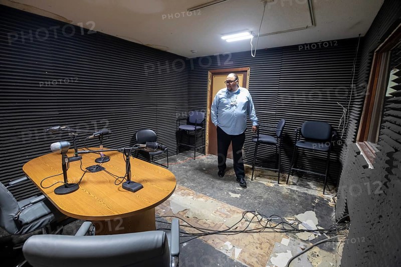 Porcupine, South Dakota - KILI Radio, the voice of the Lakota Nation. Station manager Oitancan Mani Zephier stands in 'Studio B, ' which needs repairs. The station broadcasts in Lakota and English to the Pine Ridge, Cheyenne River, and Rosebud Indian Reservations. Its finances have been hurt by President Trump's dissolution of the Corporation for Public Broadcasting