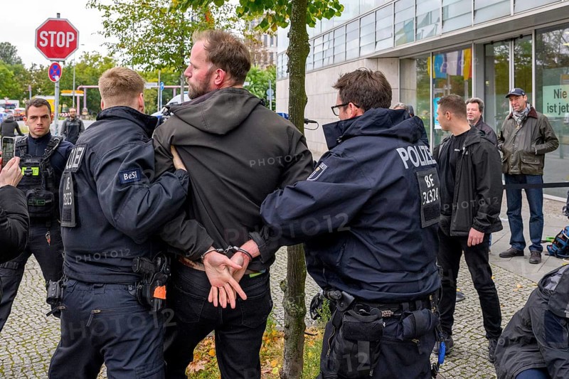 New Generation activist is arrested during an attempt by the New Generation to organise an anti-corruption performance in front of the Konrad Adenauer House, the federal headquarters of the CDU. Berlin, 06.10.2025