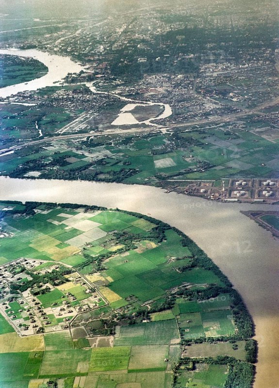 Captioned as 'aerial photo Saigon', meandering river in flat agricultural landscape of paddy fields, Vietnam, south east Asia c 1964