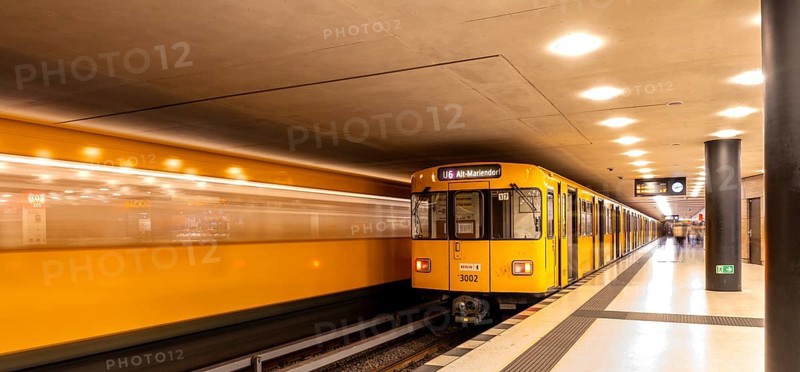Dynamic scene of a Berlin underground in typical yellow colour, long exposure with blur effect, busy traffic junction at Unter den Linden station, Berlin, Germany