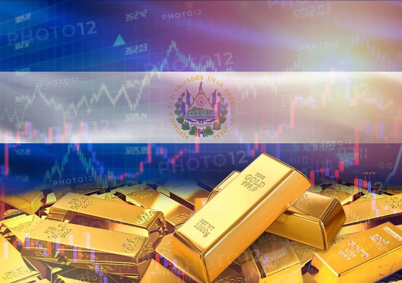 Gold bars on El Salvador flag in background. Gold bars stacked on Salvadoran flag. Concept of El Salvador gold reserves