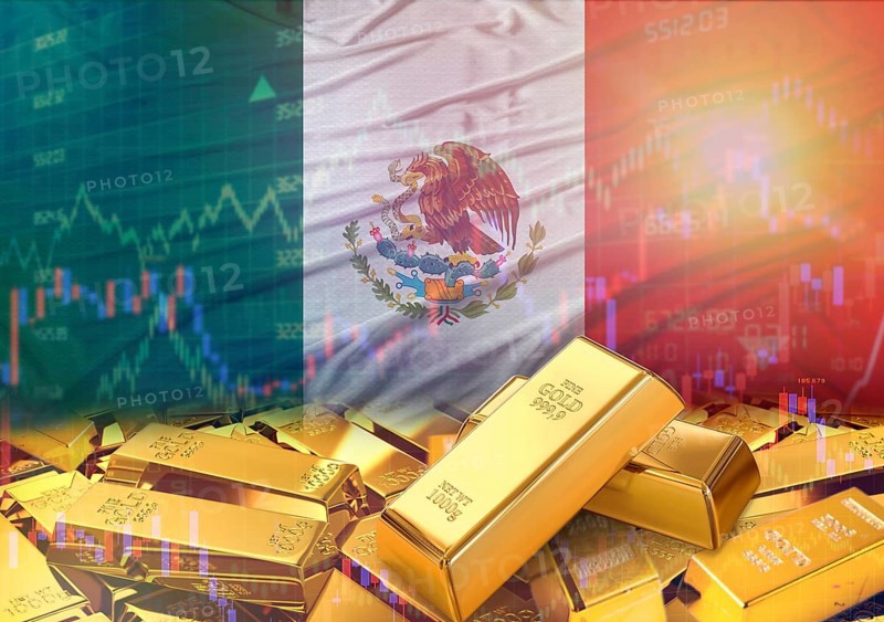 Gold bars on Mexico flag in background. Gold bars stacked on Mexican flag. Concept of Mexico gold reserves