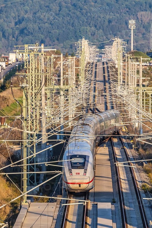 Deutsche Bahn AG high-speed railway line between Stuttgart and Ulm. New railway line with ICE of Deutsche Bahn AG with overhead lines and railway technology. Kirchheim unter Teck, Baden-Württemberg, Germany